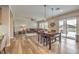 Open-concept living area with a sectional sofa, shutters, and adjacent dining area and kitchen at 8216 Tursi Lodge Ct, Las Vegas, NV 89131