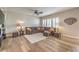 Comfortable living room with ceiling fan, plantation shutters, and a cozy sectional sofa at 8216 Tursi Lodge Ct, Las Vegas, NV 89131