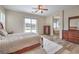 Spacious main bedroom with hardwood floors, ceiling fan, and sliding glass door to the backyard at 8216 Tursi Lodge Ct, Las Vegas, NV 89131