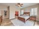 Bedroom with hardwood floors, windows with plantation shutters, and access to a walk-in closet at 8216 Tursi Lodge Ct, Las Vegas, NV 89131