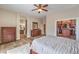 Hardwood floors in a spacious main bedroom leading to the bathroom and walk-in closet with custom shelving at 8216 Tursi Lodge Ct, Las Vegas, NV 89131