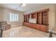 Bright office space featuring custom built-in shelves and cabinets, tile flooring, and natural light at 8216 Tursi Lodge Ct, Las Vegas, NV 89131