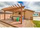 Inviting outdoor bar area with a custom pergola, wooden deck, and colorful bar stools, perfect for outdoor gatherings at 8216 Tursi Lodge Ct, Las Vegas, NV 89131