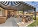 Outdoor kitchen with a built-in grill, bar seating, and sink, perfect for alfresco dining and entertaining at 8216 Tursi Lodge Ct, Las Vegas, NV 89131