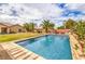 Sparkling pool in a private backyard, surrounded by lush landscaping and ample space for outdoor seating and relaxation at 8216 Tursi Lodge Ct, Las Vegas, NV 89131