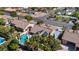 Aerial shot of home featuring a pool, solar panels, tile roof, palm trees and manicured landscaping at 8216 W Hammer Ln, Las Vegas, NV 89149