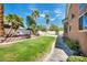 Spacious backyard with a well-kept lawn, mature trees, and a glimpse of the refreshing pool at 8216 W Hammer Ln, Las Vegas, NV 89149