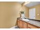 Half bathroom with granite countertop and custom wood cabinets at 8216 W Hammer Ln, Las Vegas, NV 89149