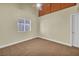 Bedroom with neutral carpeting and walls, ceiling fan, window, and door to other rooms at 8216 W Hammer Ln, Las Vegas, NV 89149