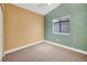 Cozy bedroom with neutral walls, plush carpeting, and a window offering natural light at 8216 W Hammer Ln, Las Vegas, NV 89149