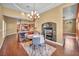 Open-concept dining room features a fireplace, chandelier, and view to the kitchen at 8216 W Hammer Ln, Las Vegas, NV 89149