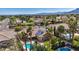 Aerial view of a home with solar panels, tile roof, refreshing pool, and lush palm trees at 8216 W Hammer Ln, Las Vegas, NV 89149