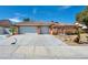 Inviting single-story home with a spacious three-car garage and well-maintained front yard at 8216 W Hammer Ln, Las Vegas, NV 89149
