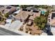 Aerial view of a well-maintained home with a three-car garage, solar panels, and landscaped front yard at 8216 W Hammer Ln, Las Vegas, NV 89149