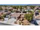 Aerial view of home featuring tile roof, solar panels, and a two-car garage at 8216 W Hammer Ln, Las Vegas, NV 89149
