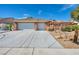 Single story home with a three car garage and desert landscaping at 8216 W Hammer Ln, Las Vegas, NV 89149