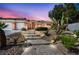 Charming home featuring a stone pathway with solar lighting and desert landscaping at 8216 W Hammer Ln, Las Vegas, NV 89149