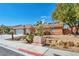 Charming single-story home featuring a landscaped front yard with desert plants and a red tile roof at 8216 W Hammer Ln, Las Vegas, NV 89149