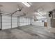 Spacious three-car garage with ample storage cabinets and overhead door openers at 8216 W Hammer Ln, Las Vegas, NV 89149