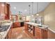 Open concept kitchen with stone countertops, custom cabinets and stainless steel appliances at 8216 W Hammer Ln, Las Vegas, NV 89149