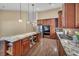 Kitchen with stone countertops, hardwood floors, and stainless steel appliances at 8216 W Hammer Ln, Las Vegas, NV 89149