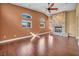 Spacious living room features a stone fireplace, hardwood floors and large windows at 8216 W Hammer Ln, Las Vegas, NV 89149