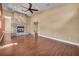 Open living room with hardwood floors and a stone fireplace feature at 8216 W Hammer Ln, Las Vegas, NV 89149