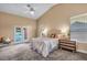 Bright main bedroom boasts cathedral ceilings, neutral walls, plush carpet and access to pool at 8216 W Hammer Ln, Las Vegas, NV 89149