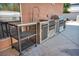 Built-in outdoor kitchen featuring stone accents, stainless steel grill and prep station with sink at 8216 W Hammer Ln, Las Vegas, NV 89149