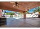 Covered patio with ceiling fans, view of fenced pool, and outdoor kitchen perfect for entertaining at 8216 W Hammer Ln, Las Vegas, NV 89149