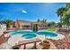 Stunning backyard pool and spa area, complemented by a beautifully landscaped yard and the home's exterior at 8216 W Hammer Ln, Las Vegas, NV 89149