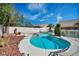 Resort-style pool and spa area with mature trees and meticulous landscaping in a private backyard at 8216 W Hammer Ln, Las Vegas, NV 89149