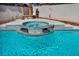 Inviting pool featuring a built-in jacuzzi with stone accents and tranquil waterfalls at 8216 W Hammer Ln, Las Vegas, NV 89149