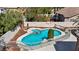 Backyard pool area features a sparkling pool, spa, and well-maintained landscaping at 8216 W Hammer Ln, Las Vegas, NV 89149
