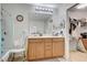 Bathroom with double sink vanity, walk-in closet access, and accessible shower at 8783 Halcon Ave, Las Vegas, NV 89148