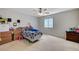 A spacious bedroom is brightened by a large window and modern ceiling fan at 8783 Halcon Ave, Las Vegas, NV 89148