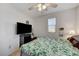 Relaxing bedroom showcasing modern fan, bright window, and neutral decor at 8783 Halcon Ave, Las Vegas, NV 89148