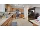 Traditional kitchen featuring wood cabinets, stainless steel appliances and tile flooring at 8783 Halcon Ave, Las Vegas, NV 89148