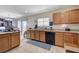 Spacious kitchen featuring granite countertops, wood cabinetry, and natural light at 8783 Halcon Ave, Las Vegas, NV 89148