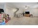 Spacious living room features a ceiling fan and access to the stairs at 8783 Halcon Ave, Las Vegas, NV 89148