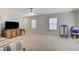 Spacious living room with plush carpeting, natural light, and a media center for entertainment at 8783 Halcon Ave, Las Vegas, NV 89148
