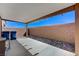 A covered patio with a brick wall, perfect for outdoor enjoyment at 8783 Halcon Ave, Las Vegas, NV 89148