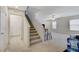Carpeted staircase leading to the upper level, filled with natural light at 8783 Halcon Ave, Las Vegas, NV 89148