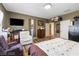 Spacious bedroom features a wall-mounted TV, wood flooring, and comfortable seating, perfect for relaxation at 916 Bob Barney Ave, North Las Vegas, NV 89086