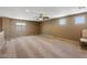 Large bonus room with neutral carpet and multiple windows offering versatile living space options at 916 Bob Barney Ave, North Las Vegas, NV 89086