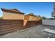 Spacious backyard featuring a gravel ground cover, brick wall, and access to nearby homes at 9526 Summer Furnace St, Las Vegas, NV 89178