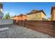 Spacious backyard featuring a gravel ground cover, brick wall, and access to nearby homes at 9526 Summer Furnace St, Las Vegas, NV 89178