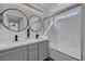 Modern bathroom featuring double sinks, a tub-shower combo, and decorative mirrors at 9526 Summer Furnace St, Las Vegas, NV 89178
