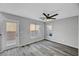 This is a spacious bedroom with natural light, ceiling fan, and wood-look flooring at 9526 Summer Furnace St, Las Vegas, NV 89178