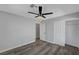 Cozy bedroom featuring wood-style floors, a fan, and gray paint at 9526 Summer Furnace St, Las Vegas, NV 89178
